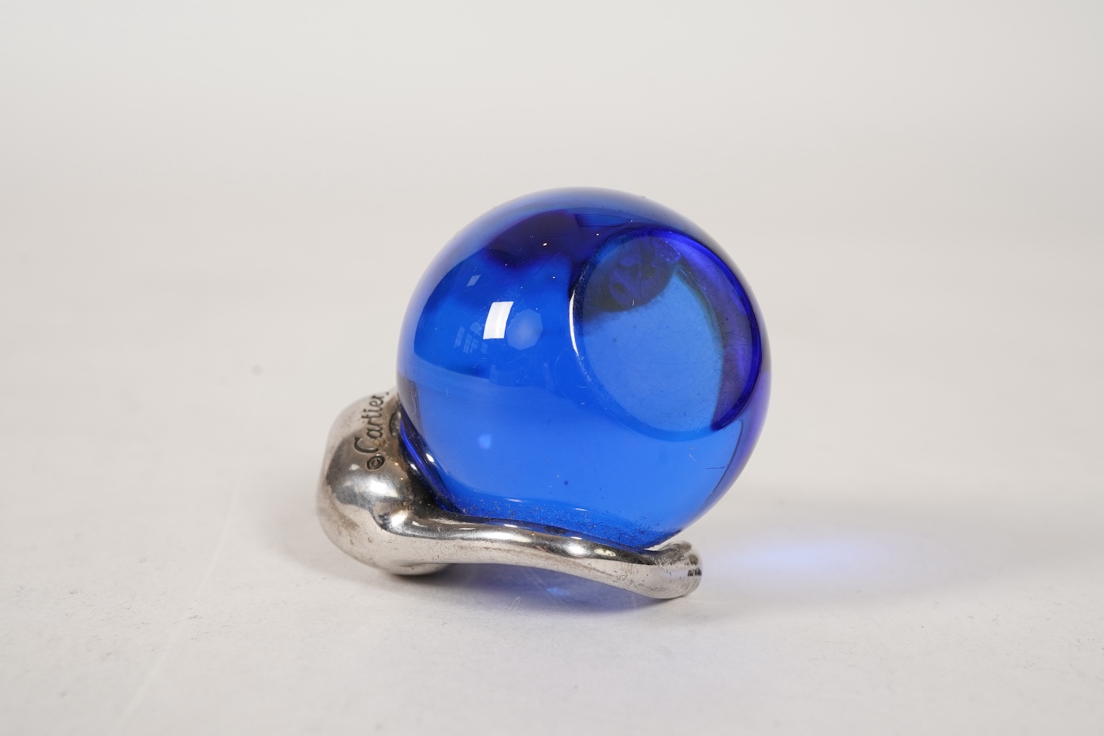 A recent Cartier paperweight, modelled as a panther upon a blue glass sphere
